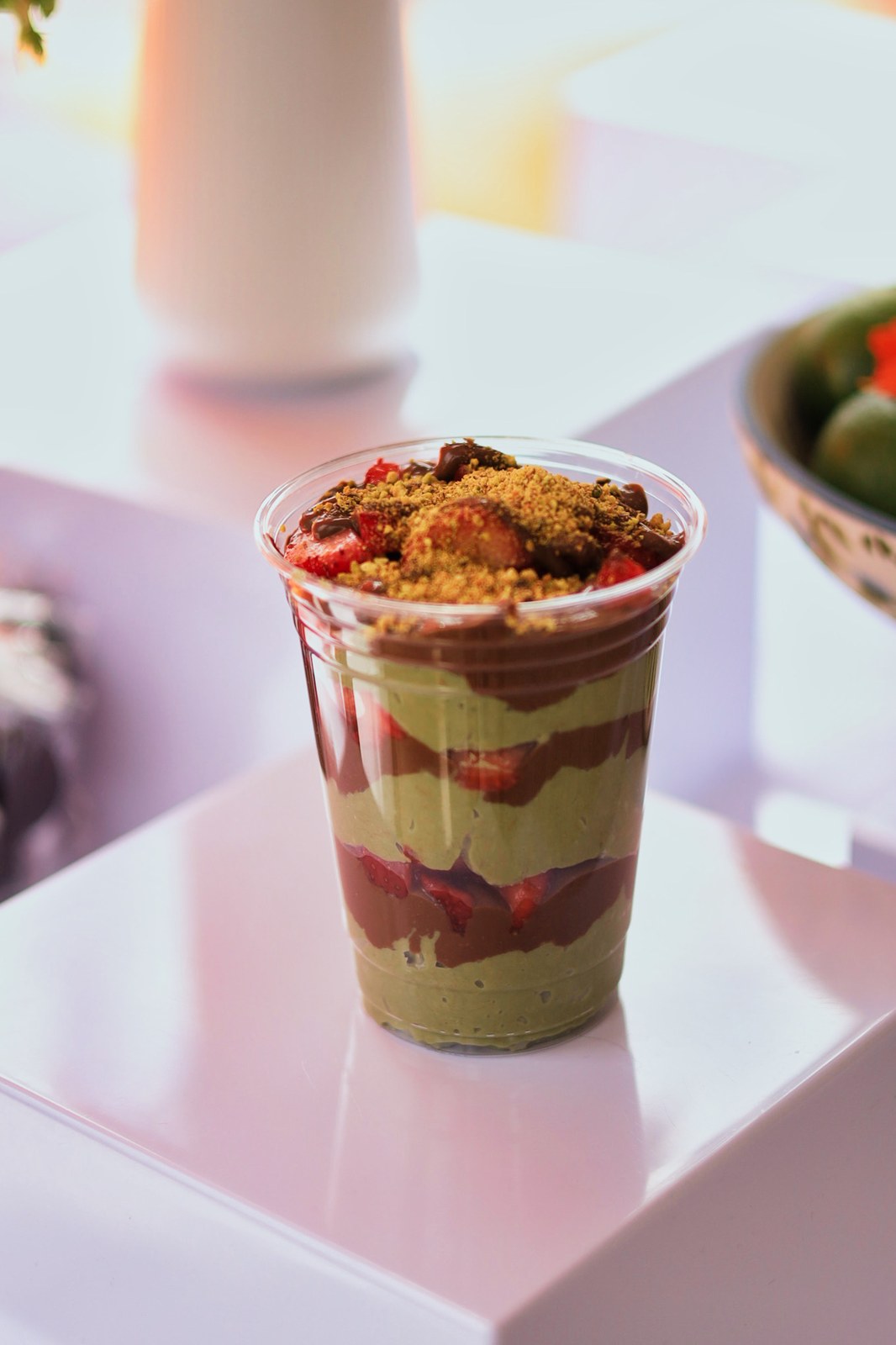 Layered dessert cup with fruit and chocolate at Blend and Bliss